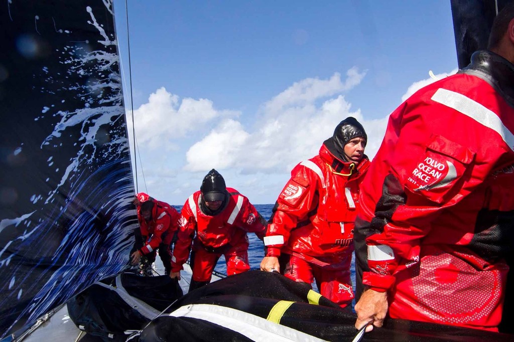Kelvin Harrap looks up while moving a sail off the foredeck after a jib change. PUMA Ocean Racing powered by BERG during leg 2 of the Volvo Ocean Race 2011-12  © Amory Ross/Puma Ocean Racing/Volvo Ocean Race http://www.puma.com/sailing
